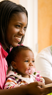 An African American mother with her child wearing a happy smile